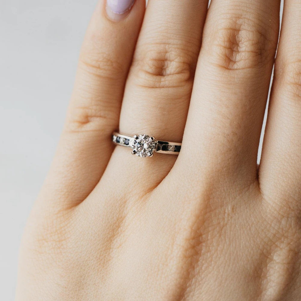 Triple X Round Brilliant Diamond and Sapphire Accented Solitaire Ring